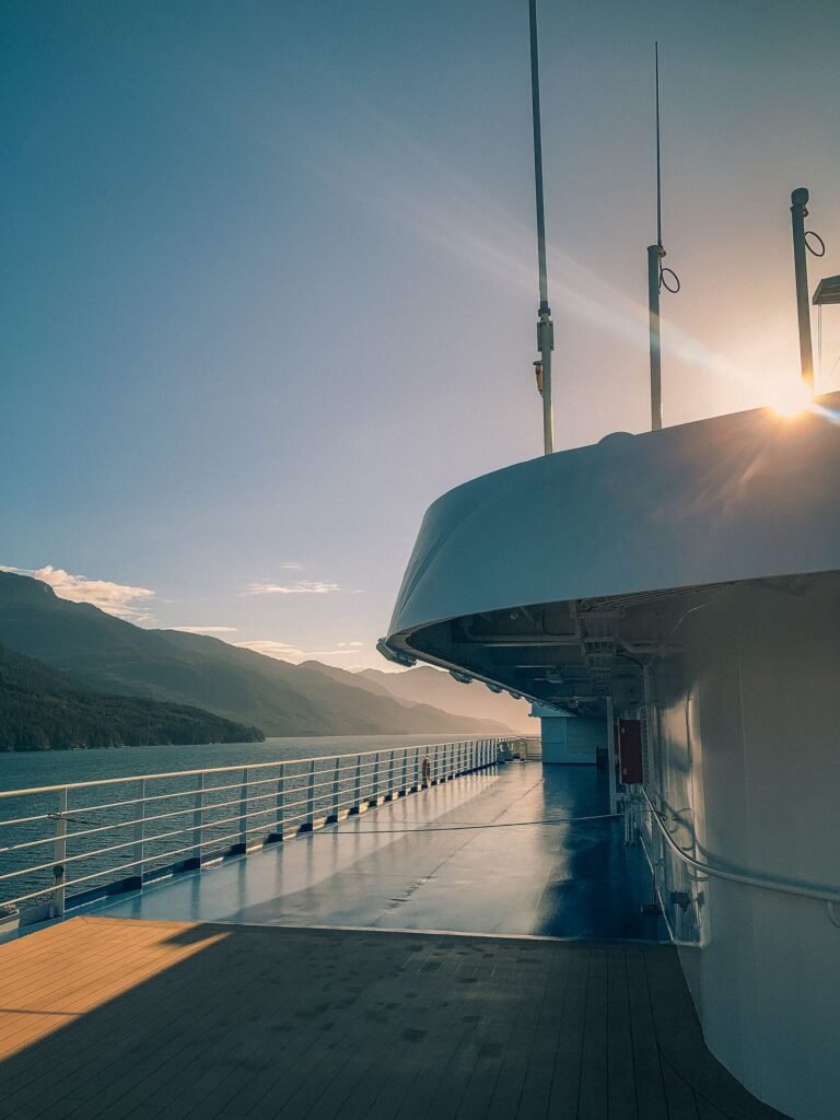 Alaska's mountains and Inside Passage seen from a cruise ship's open deck at sunset