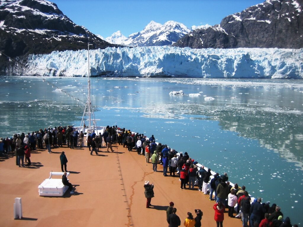 Cruise ship passengers lining the bow deck as the ship faces Margerie Glacier in Glacier Bay, Alaska