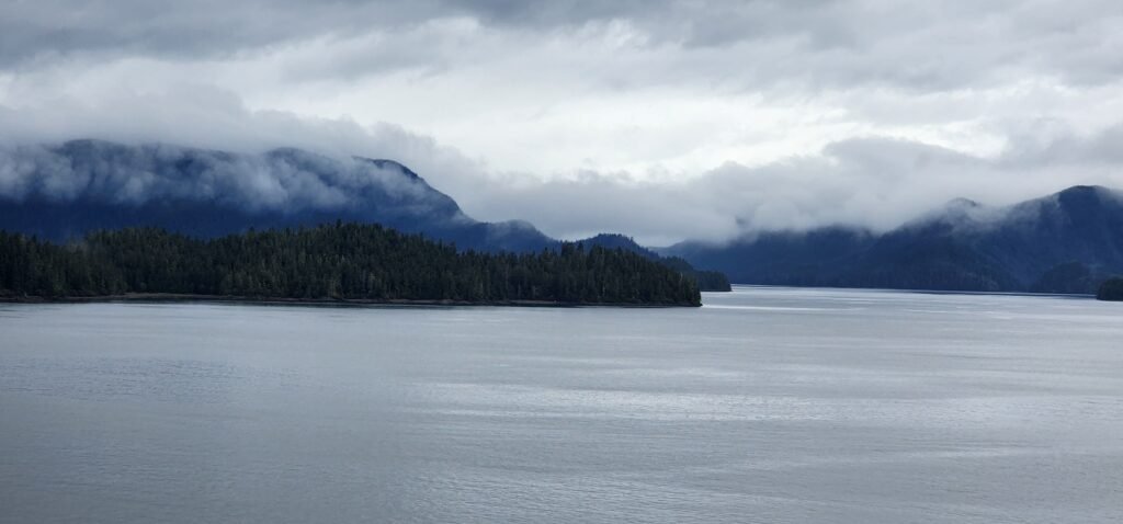 Moody low clouds over the mountains and water of Alaska's Inside Passage.