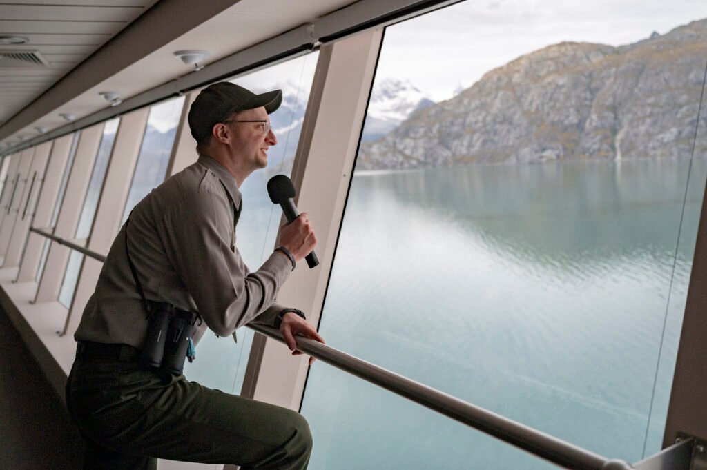 Park ranger narrating Glacier Bay over the ship's microphone during an Alaska cruise