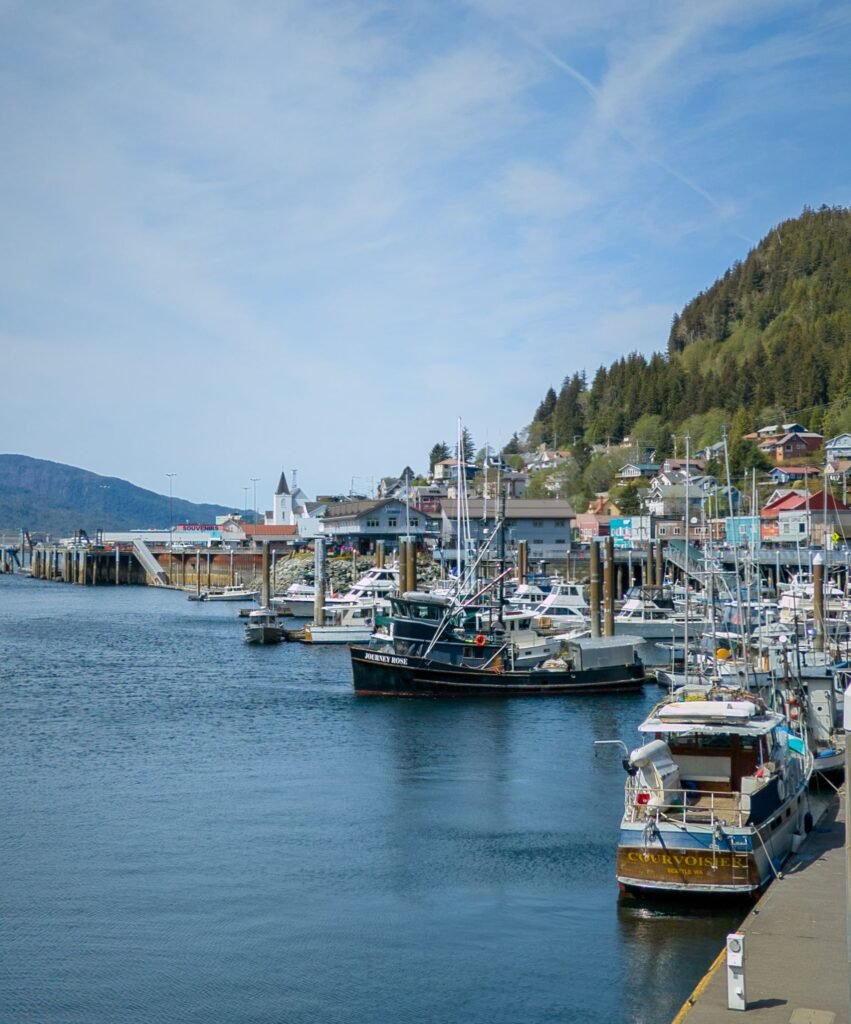 Ketchikan Alaska cruise port harbor with fishing boats and forested hillside